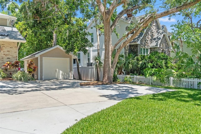 520 Lafayette Blvd, Oldsmar, FL 34677 - view of home's exterior with concrete driveway, an outbuilding, a garage, and fence