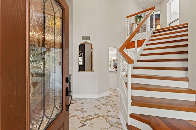 520 Lafayette Blvd, Oldsmar, FL 34677 - entryway with baseboards, marble finish floor, visible vents, stairs, and a high ceiling