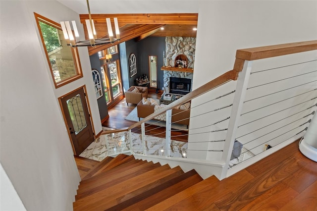520 Lafayette Blvd, Oldsmar, FL 34677 - foyer featuring stairway, a chandelier, a stone fireplace, and vaulted ceiling with beams