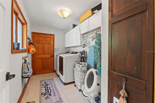 520 Lafayette Blvd, Oldsmar, FL 34677 - clothes washing area with washer and dryer, cabinet space, baseboards, and light tile patterned flooring