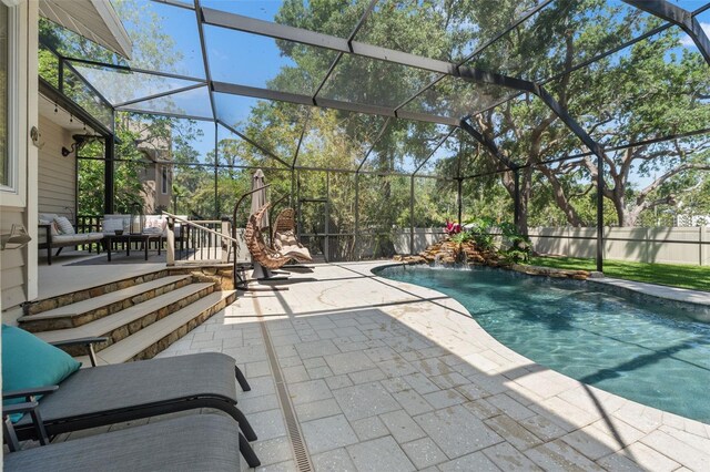 520 Lafayette Blvd, Oldsmar, FL 34677 - view of swimming pool featuring glass enclosure, a patio, a fenced in pool, and a fenced backyard