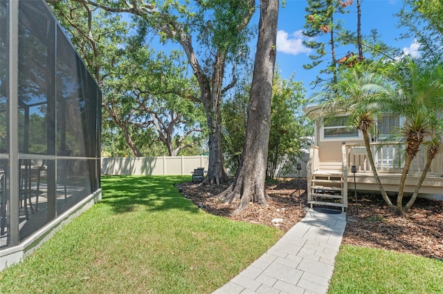 520 Lafayette Blvd, Oldsmar, FL 34677 - view of yard with glass enclosure, a wooden deck, and fence