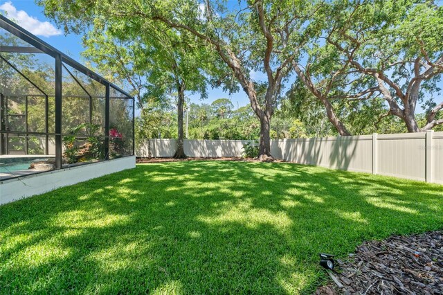 520 Lafayette Blvd, Oldsmar, FL 34677 - view of yard featuring a fenced backyard, a fenced in pool, and glass enclosure