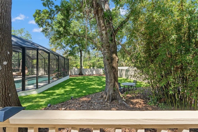 520 Lafayette Blvd, Oldsmar, FL 34677 - view of yard featuring glass enclosure, a fenced in pool, and a fenced backyard