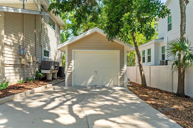 520 Lafayette Blvd, Oldsmar, FL 34677 - detached garage featuring central air condition unit, concrete driveway, and fence