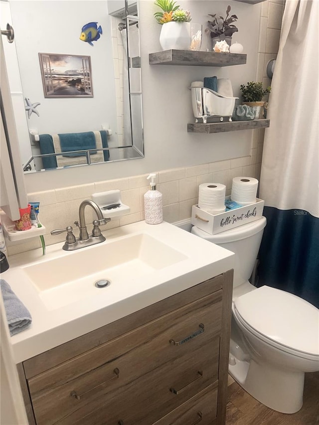 4264 Tamargo Dr Unit 3, New Port Richey, FL 34652 - bathroom featuring tile walls, toilet, wood finished floors, vanity, and a shower with shower curtain