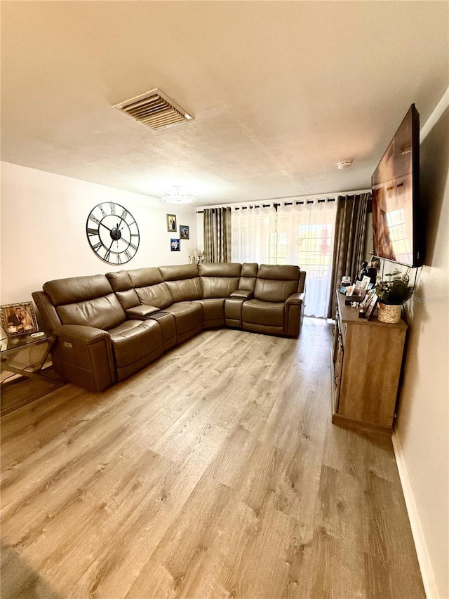 4264 Tamargo Dr Unit 3, New Port Richey, FL 34652 - living room with baseboards, visible vents, and wood finished floors
