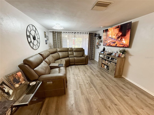4264 Tamargo Dr Unit 3, New Port Richey, FL 34652 - living area with visible vents, wood finished floors, and baseboards