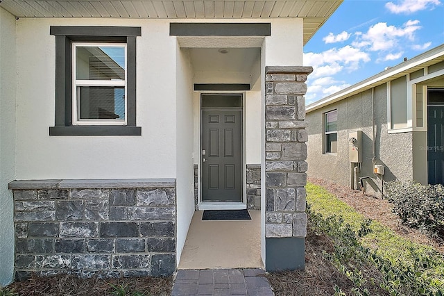 4106 NW 44th Cir, Ocala, FL 34482 - doorway to property featuring stucco siding and stone siding