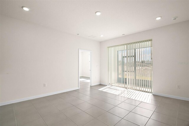4106 NW 44th Cir, Ocala, FL 34482 - tiled spare room with baseboards and recessed lighting