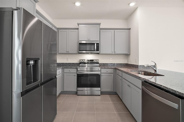 4106 NW 44th Cir, Ocala, FL 34482 - kitchen featuring stainless steel appliances, gray cabinets, a sink, and dark stone countertops