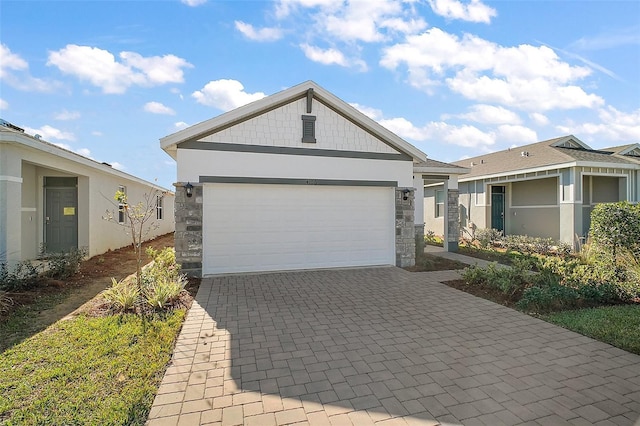 4106 NW 44th Cir, Ocala, FL 34482 - ranch-style home with stucco siding, decorative driveway, stone siding, and a garage