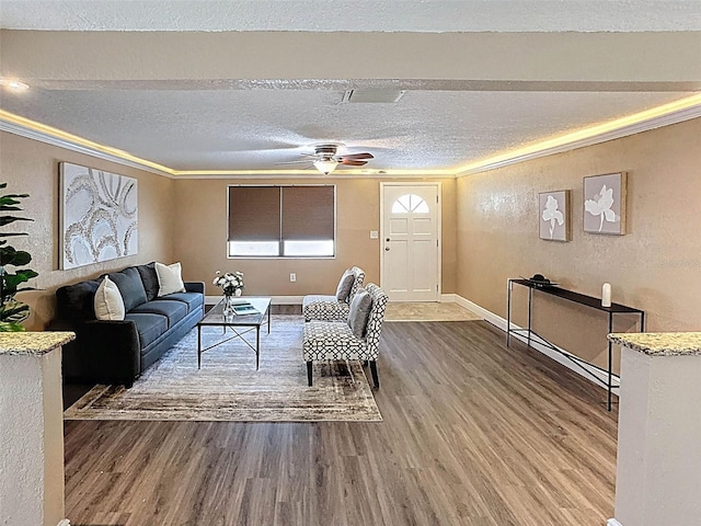 living area with a textured ceiling, a textured wall, and wood finished floors