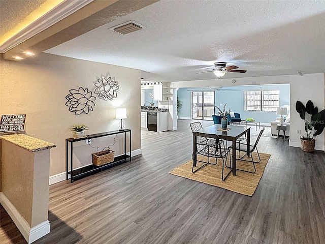dining room featuring baseboards, a ceiling fan, dark wood-style floors, and visible vents