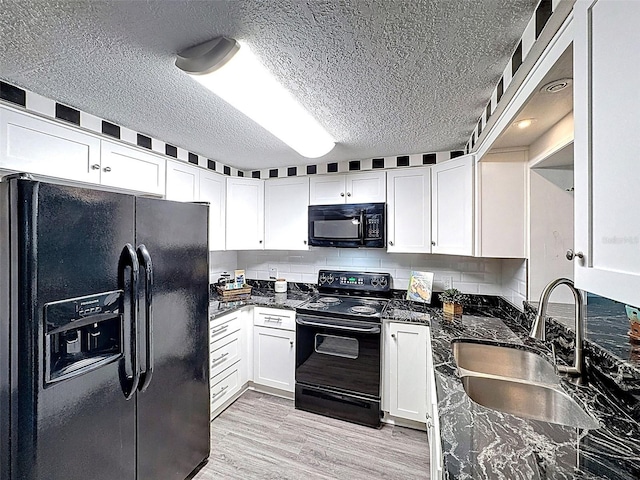 kitchen with a sink, white cabinets, a textured ceiling, and black appliances
