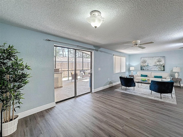 office area with a textured ceiling, baseboards, and wood finished floors