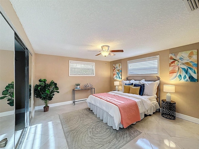 bedroom with light tile patterned flooring, baseboards, and multiple windows