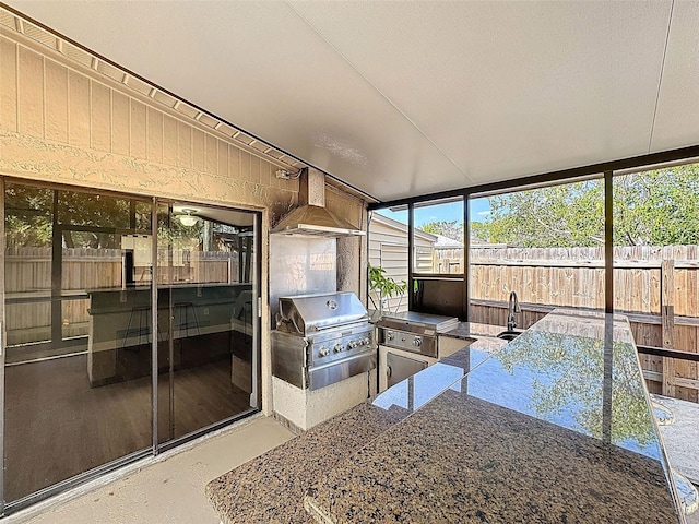 sunroom featuring a sink and area for grilling