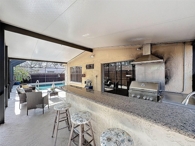 view of patio with grilling area, area for grilling, a lanai, an outdoor pool, and outdoor wet bar