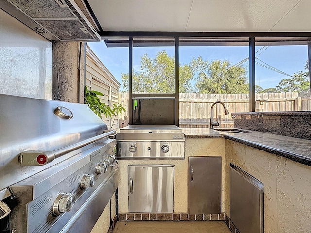view of patio / terrace featuring fence, a sink, a grill, and area for grilling