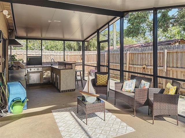 sunroom / solarium featuring an outdoor kitchen and plenty of natural light