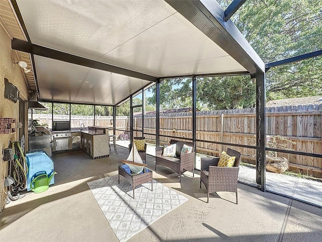 sunroom with an outdoor kitchen and an outdoor living space