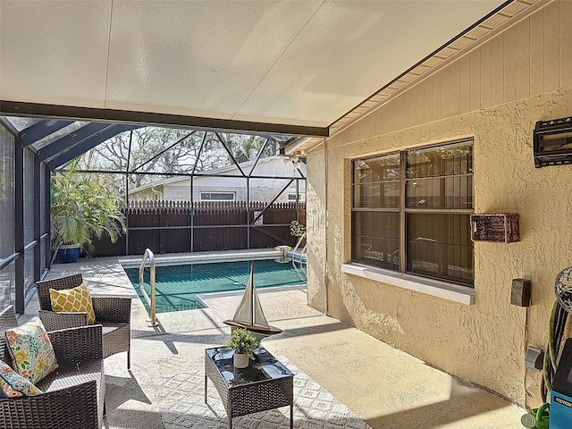 view of pool featuring fence, a fenced in pool, a patio, and glass enclosure