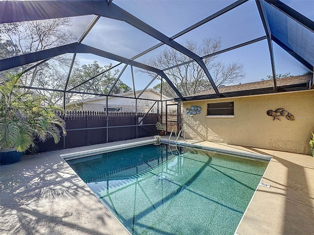view of pool featuring a fenced in pool, fence, a patio, and a lanai