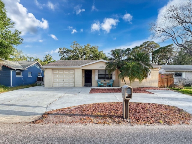 ranch-style house with brick siding, an attached garage, driveway, and a porch