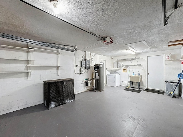 basement with water heater, separate washer and dryer, a textured ceiling, and a garage