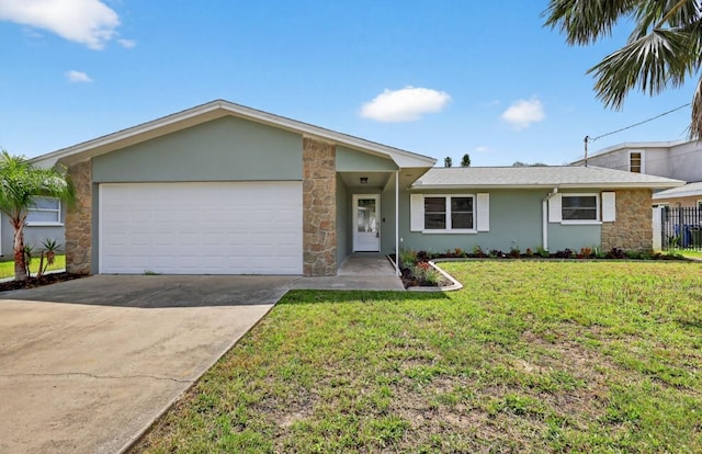 2175 Edythe Dr, Dunedin, FL 34698 - view of front of home featuring stone siding, a garage, driveway, and stucco siding