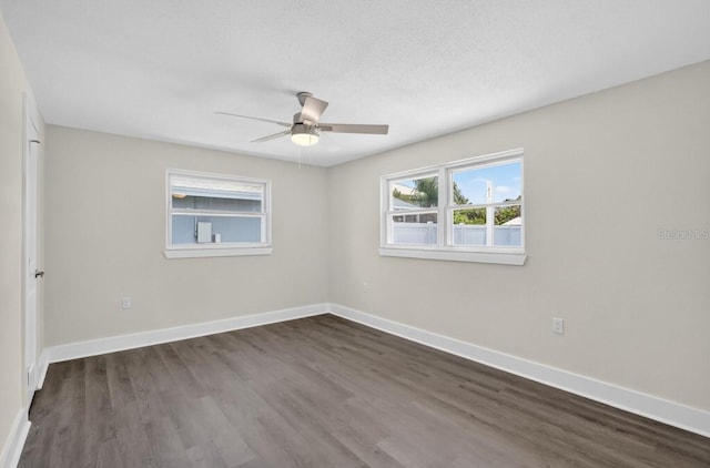 2175 Edythe Dr, Dunedin, FL 34698 - unfurnished room featuring a ceiling fan and dark wood-type flooring