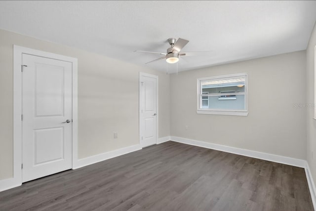 2175 Edythe Dr, Dunedin, FL 34698 - unfurnished bedroom with dark wood finished floors and ceiling fan
