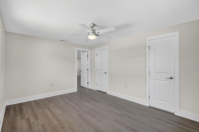 2175 Edythe Dr, Dunedin, FL 34698 - unfurnished bedroom featuring dark wood finished floors and a ceiling fan
