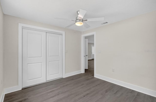 2175 Edythe Dr, Dunedin, FL 34698 - unfurnished bedroom featuring wood finished floors, a closet, and ceiling fan