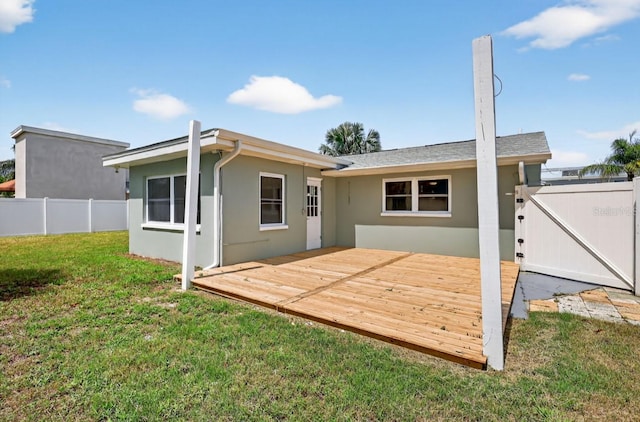 2175 Edythe Dr, Dunedin, FL 34698 - rear view of property with stucco siding, a deck, and a gate