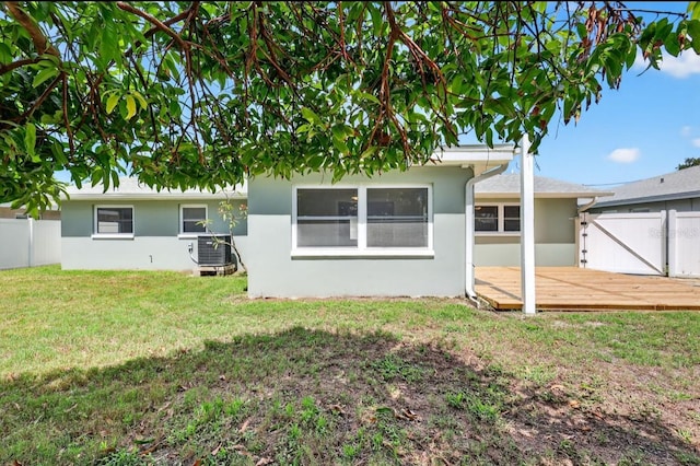 2175 Edythe Dr, Dunedin, FL 34698 - rear view of property with stucco siding and a wooden deck
