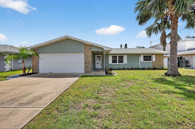 2175 Edythe Dr, Dunedin, FL 34698 - view of front of house with an attached garage, stone siding, driveway, a front lawn, and stucco siding