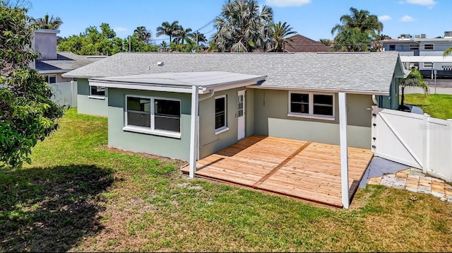2175 Edythe Dr, Dunedin, FL 34698 - back of property with stucco siding, a wooden deck, a shingled roof, and a gate