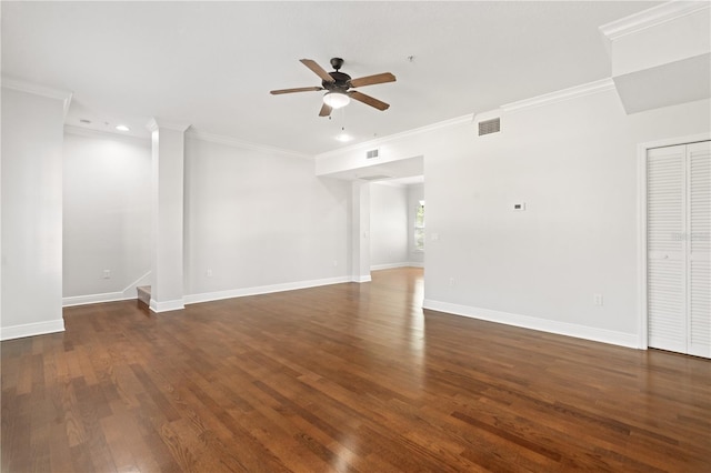unfurnished living room with a ceiling fan, visible vents, wood finished floors, baseboards, and ornamental molding