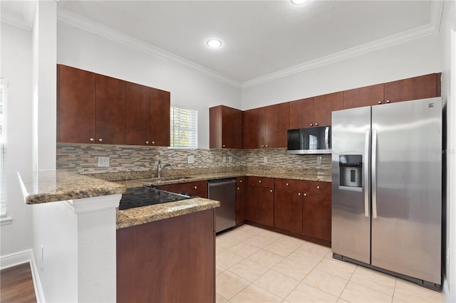 kitchen featuring stone countertops, stainless steel appliances, a peninsula, tasteful backsplash, and ornamental molding