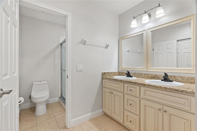 full bathroom with double vanity, a sink, a stall shower, and toilet