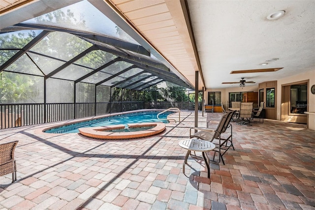 663 Turnberry Ct, Tarpon Springs, FL 34688 - view of pool with ceiling fan, a patio area, a pool with connected hot tub, and glass enclosure