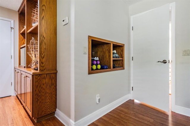 663 Turnberry Ct, Tarpon Springs, FL 34688 - hall featuring baseboards and light wood finished floors