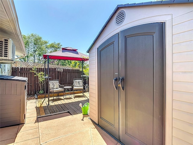 view of shed with fence and a gazebo