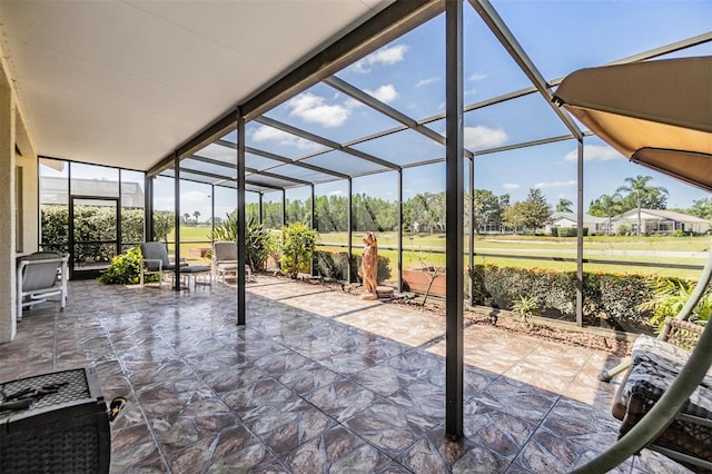 view of patio / terrace featuring glass enclosure