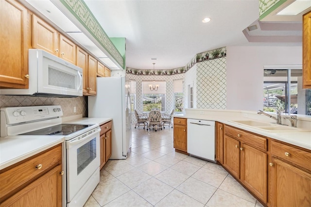 kitchen featuring a sink, light tile patterned floors, white appliances, and light countertops