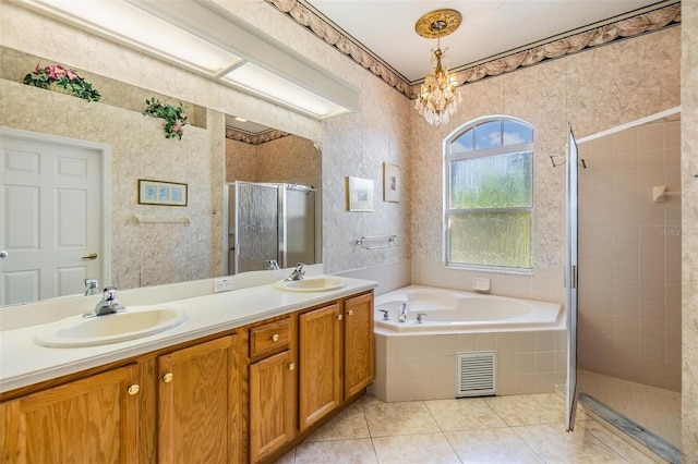 bathroom featuring visible vents, a bath, tile patterned floors, a sink, and a stall shower