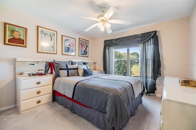 bedroom featuring baseboards, a ceiling fan, and light carpet
