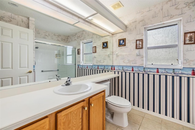 bathroom with tile patterned flooring, toilet, wallpapered walls, visible vents, and a stall shower